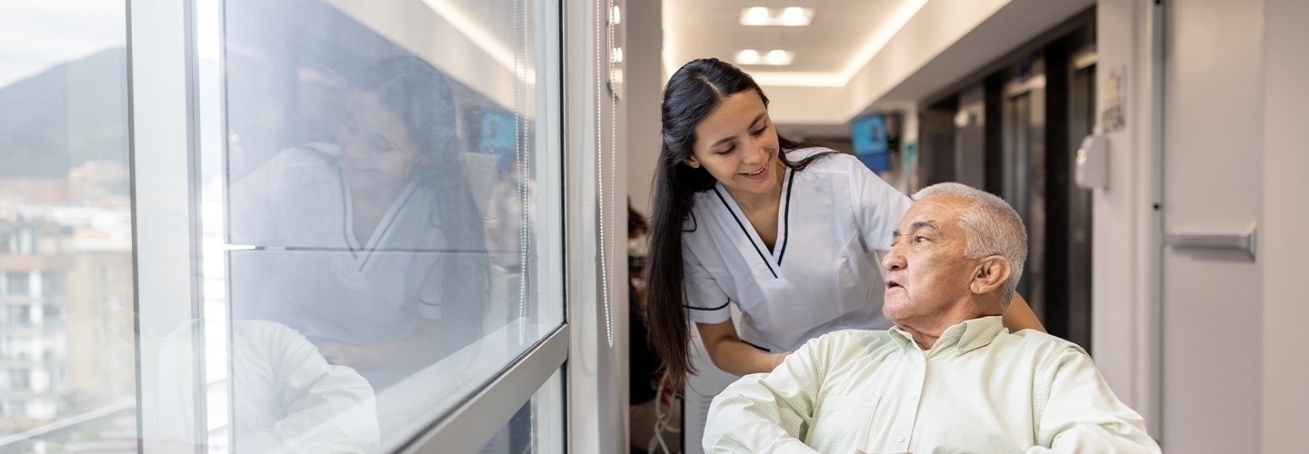 nurse helping a senior man in a wheelchair